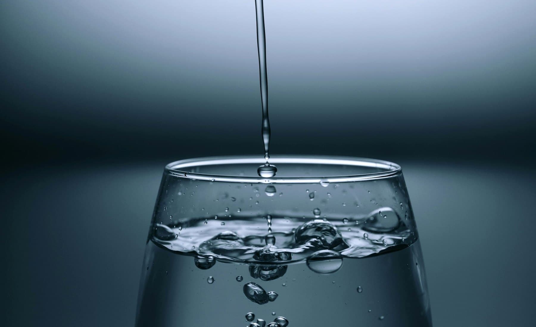 Clear drinking water pouring into a glass