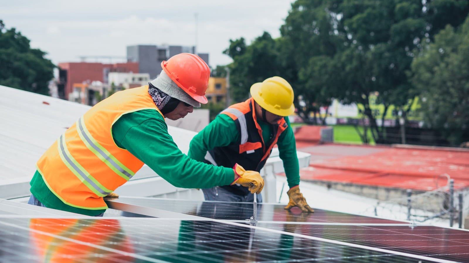 Crew installing rooftop solar panels on a residential home