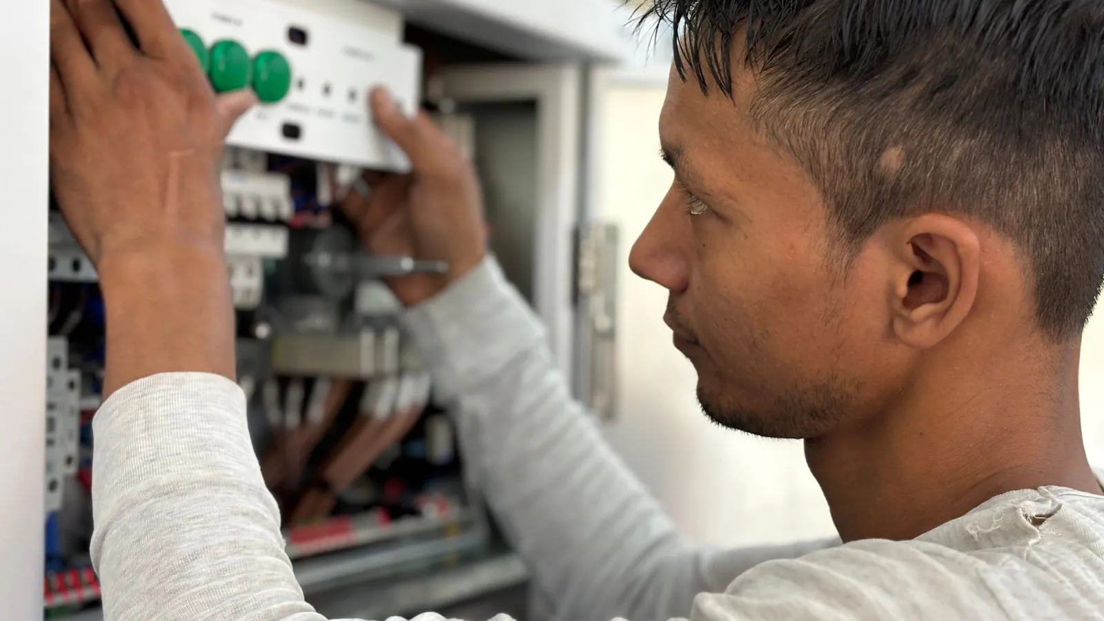 Electrician working on a home electrical panel for backup power